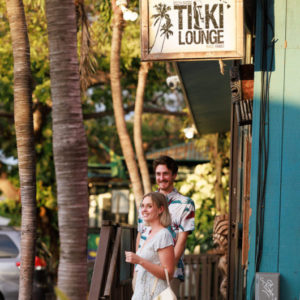 a young couple walking out of a restaurant staircase