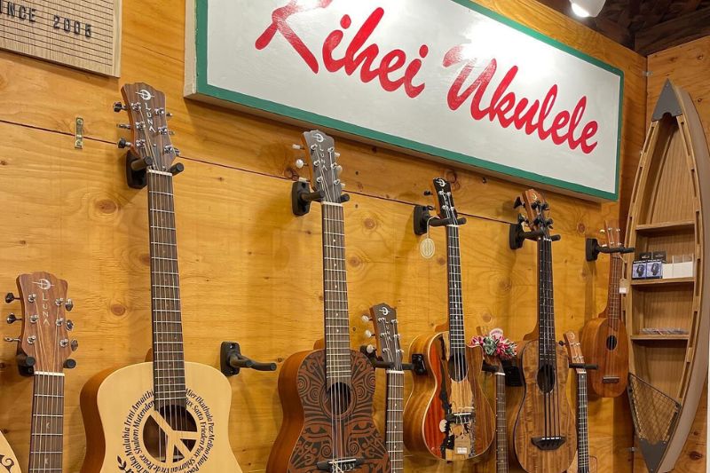 wall filled with ukuleles and store sign